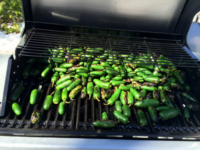 Green peppers cooking on the grill.